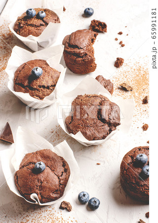 Homemade fresh chocolate muffins with berries and chocolate pieces. 65991181