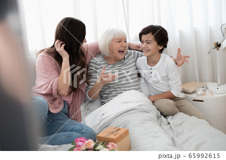 High-spirited woman laughing and gesticulating with her hands 65992615