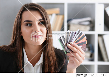 Business woman in the office holds a plastic credit debit card in her hand Business woman in the office holds a plastic credit debit card in her hand 65992619