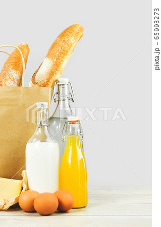 Two french baguette bread loafs in paper bag and 65993273