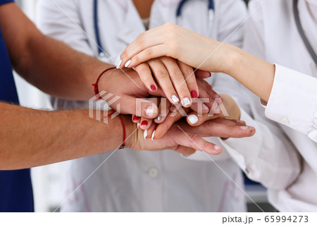 Group of doctor crossed arms in pile for win 65994273