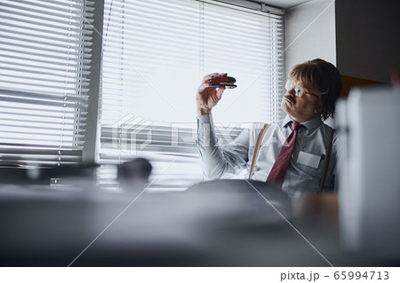 Journalist getting inspiration by interacting with stationery supplies Journalist getting inspiration by interacting with stationery supplies 65994713