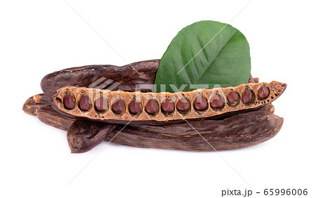 Ripe carob pods and bean isolated on white Ripe carob pods and bean isolated on white 65996006