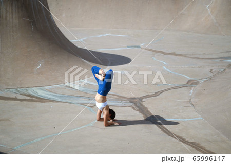 Asian chinese woman doing street yoga in public Asian chinese woman doing street yoga in public 65996147