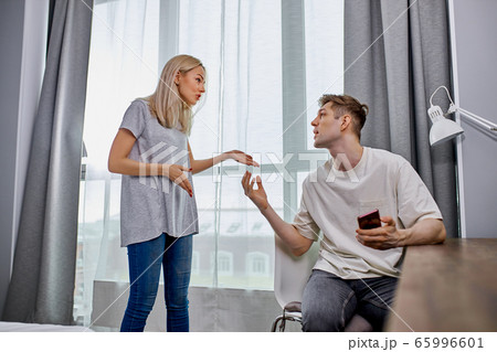 young woman unhappy that man is constantly messing around 65996601