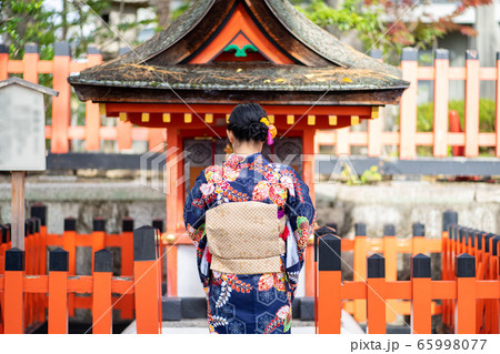 Geishas girl wearing Japanese kimono among red Geishas girl wearing Japanese kimono among red 65998077