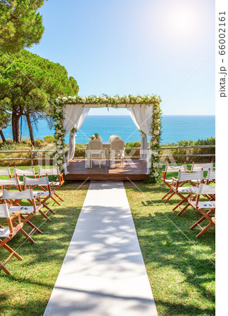 Beautiful wedding by the ocean, outdoors on a sunny day. Beautiful wedding by the ocean, outdoors on a sunny day. 66002161