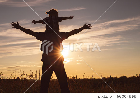 Father and son playing in the park at the sunset Father and son playing in the park at the sunset 66004999