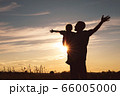 Father and son playing in the park at the sunset 66005000