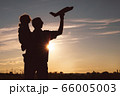 Father and son playing in the park at the sunset 66005003