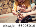 little boy is playing with a chick at the day 66005010