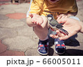 little boy is playing with a chick at the day 66005011