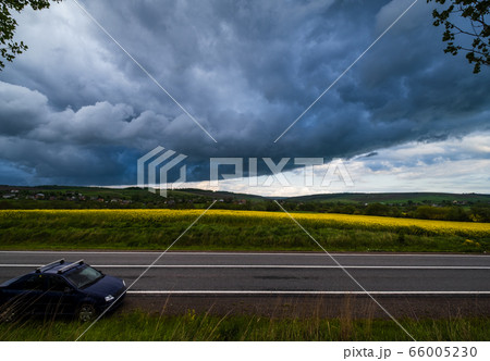 Dramatic thunderstorm cloud over countryside and Dramatic thunderstorm cloud over countryside and 66005230