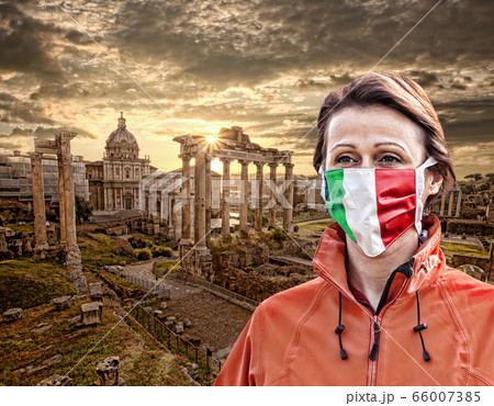 Woman wearing protection face mask with Italian flag against coronavirus near Roman ruins,Rome,Italy 66007385