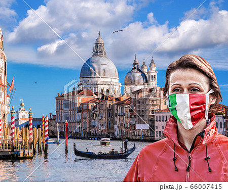 Woman wearing face mask with Italian flag against coronavirus on Grand canal in Venice,Italy Woman wearing face mask with Italian flag against coronavirus on Grand canal in Venice,Italy 66007415