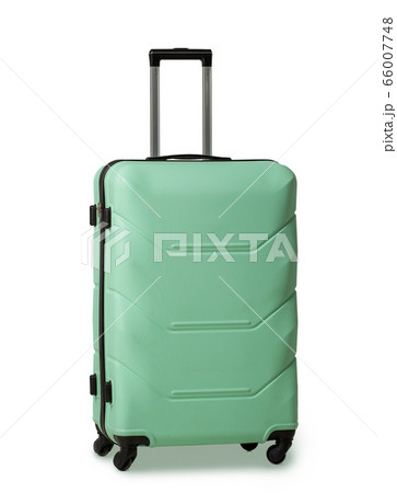 Green suitcase with retractable handle and wheels. Plastic travel luggage suitcase is reliable travel companion. Impressions of new places. Vacation concept. Isolated on white background 66007748