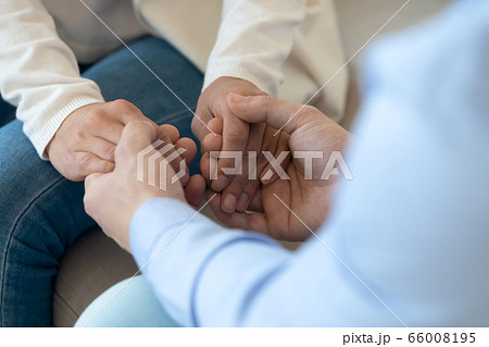 Close up of man hold beloved woman hands showing love Close up of man hold beloved woman hands showing love 66008195