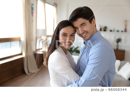 Portrait of happy young couple hug and cuddle Portrait of happy young couple hug and cuddle 66008344
