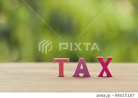 Finance tax concept: Arrangement wooden letters word TAX on table. depicts ad valorem tax on the value of the property all legitimately Finance tax concept: Arrangement wooden letters word TAX on table. depicts ad valorem tax on the value of the property all legitimately 66015187