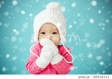 Portrait of asian baby with snow in blue background Portrait of asian baby with snow in blue background 66018141