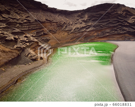 Volcanic crater with a green lake near El Golfo in Lanzarote island, Spain Volcanic crater with a green lake near El Golfo in Lanzarote island, Spain 66018831