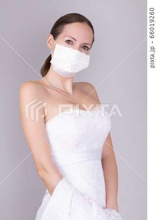 Beautiful young bride in a wedding dress and a Beautiful young bride in a wedding dress and a 66019260