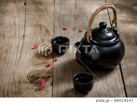 Cup of hot tea with steaming jugs on the woodCup of hot tea with steaming jugs on the wooden table background with copyspace for your text, Chinese styleen 66019347