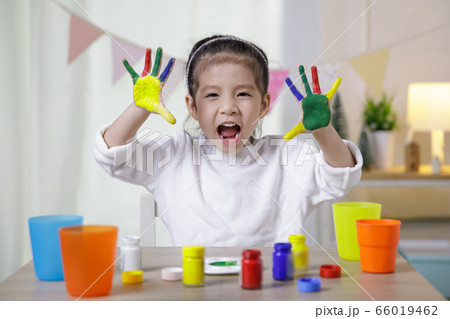 Kid's creativity, Child little asian girl hands painted in colorful paints in the class room at home, Educational concept for school 66019462