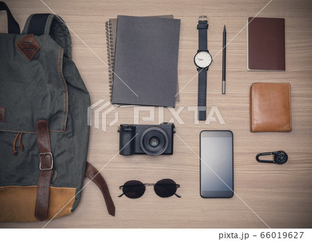 Traveler's accessories with passport, books of travel plan, wallet, camera, campass, backpack and mobile phone on oak wooden table, Flat lay with copy space, Travel concept background Traveler's accessories with passport, books of travel plan, wallet, camera, campass, backpack and mobile phone on oak wooden table, Flat lay with copy space, Travel concept background 66019627