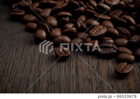 The hot of brown roasted coffee beans on brown background with copyspace, Healthy products by organic natural ingredients concept The hot of brown roasted coffee beans on brown background with copyspace, Healthy products by organic natural ingredients concept 66020679