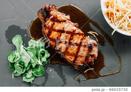 Rib eye steak with glazed honey mustard sauce and rocket salad Rib eye steak with glazed honey mustard sauce and rocket salad 66020730