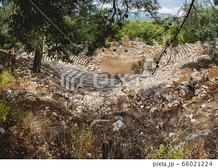 Ruins of amphitheatre of ancient Phaselis city. Panorama view on famous architectural landmark, Kemer district, Antalya province. Turkey. Ruins of amphitheatre of ancient Phaselis city. Panorama view on famous architectural landmark, Kemer district, Antalya province. Turkey. 66021224