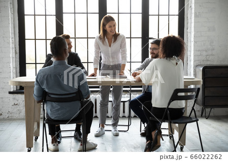 Smiling confident businesswoman team leader holding corporate briefing Smiling confident businesswoman team leader holding corporate briefing 66022262