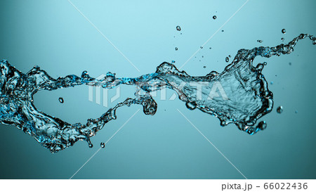 Water splash isolated on blue background 66022436