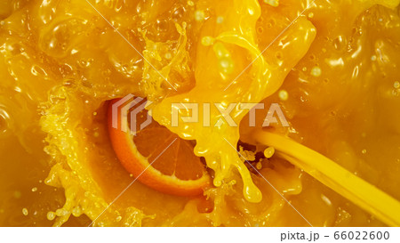 Freeze motion of pouring orange juice. 66022600