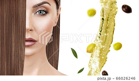 Flying green olive splash near woman with long hair. 66026246