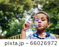 Boy playing soap bubble 66026972