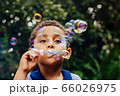 Boy playing soap bubble 66026975