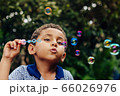 Boy playing soap bubble 66026976