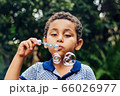 Boy playing soap bubble 66026977