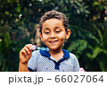 Smiling boy playing soap bubble 66027064