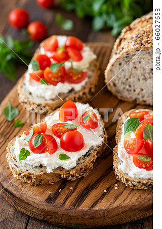 Bruschetta with fresh ricotta cheese and cherry tomatoes Bruschetta with fresh ricotta cheese and cherry tomatoes 66027653