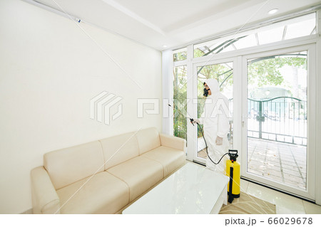 Worker disinfecting room Worker disinfecting room 66029678