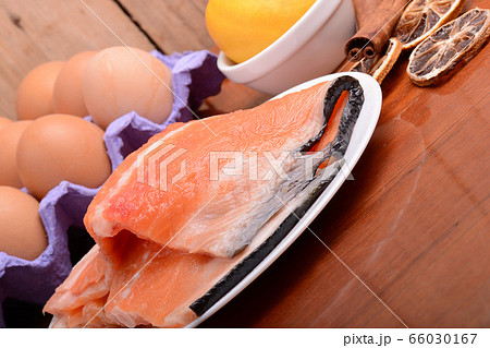 fresh salmon fillet close up on white plate. eggs, fresh salmon fillet close up on white plate. eggs, 66030167