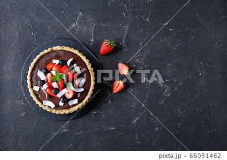 Vegan chocolate tart with nut and dates crust 66031462