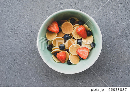 Freshly cooked pancake cereal in a bowl served with berries. Freshly cooked pancake cereal in a bowl served with berries. 66033087