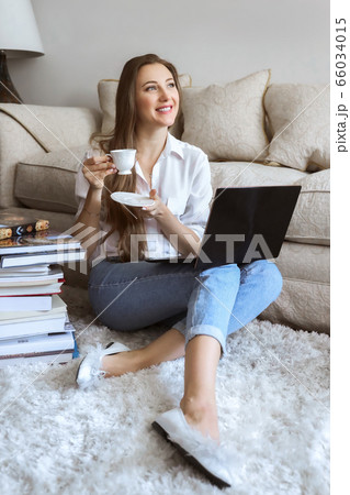 Young student watching lesson online and studying from home. Girl student studying from home 66034015