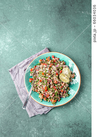 Traditional Lebanese salad tabouli tabule with quinoa, herbs, tomatoes, mint and lemon Traditional Lebanese salad tabouli tabule with quinoa, herbs, tomatoes, mint and lemon 66034036