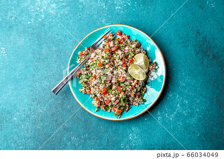 Traditional Lebanese salad tabouli tabule with quinoa, herbs, tomatoes, mint and lemon 66034049