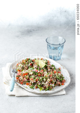 Quinoa Quinua salad with tomatoes and herbs in white bowl Quinoa Quinua salad with tomatoes and herbs in white bowl 66034060
